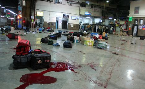 Massacre: Blood splatters the floor at the train station where travellers were slaughtered. Others abandoned their luggage and ran for their lives