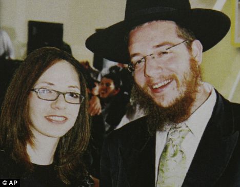 Held hostage: Rabbi Gabriel Holtzberg and his wife Rivka were held at a Jewish center. Below, their two-year-old son is carried to safety