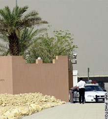 Police officers guard the entrance of a Riyadh community called the Hamra on Tuesday.